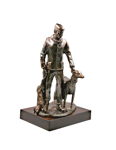 Trofeo de caza en resina decorada con la figura de un cazador, el perro y la presa. Peana de madera.